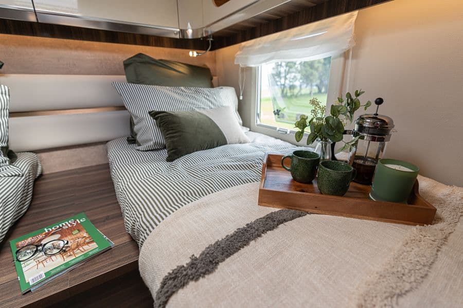 4-berth campervan bedside detail with breakfast tray, French press and styled bedding