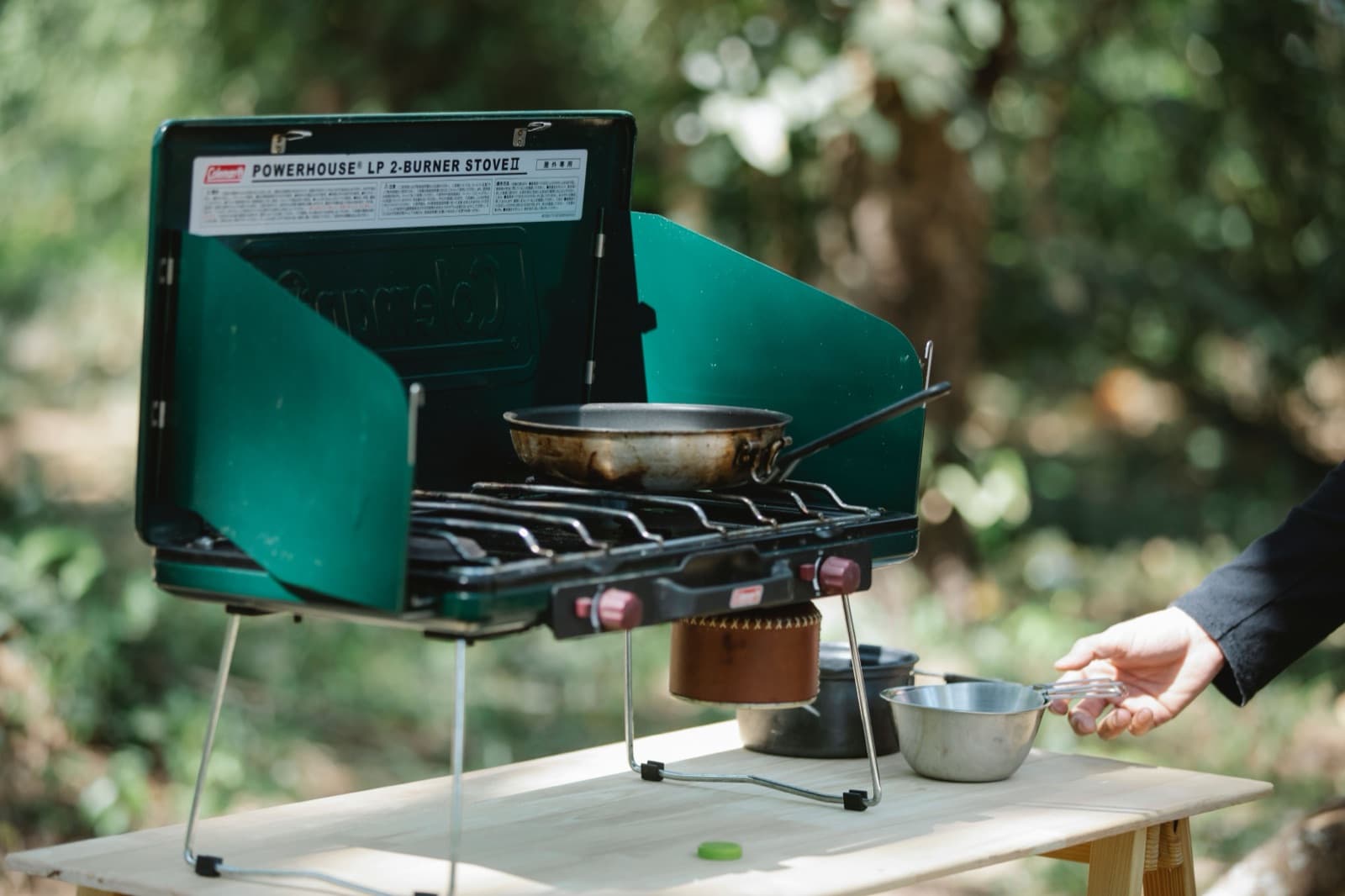 Cooking on a camp stove outside a campervan, the single biggest saving on a New Zealand road trip budget