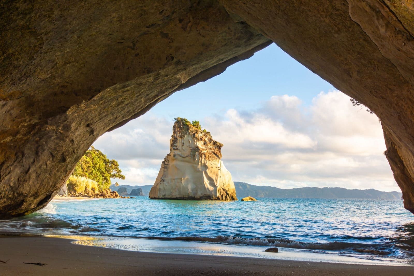Cathedral Cove on the Coromandel Peninsula seen through the rock arch, on a North Island campervan route