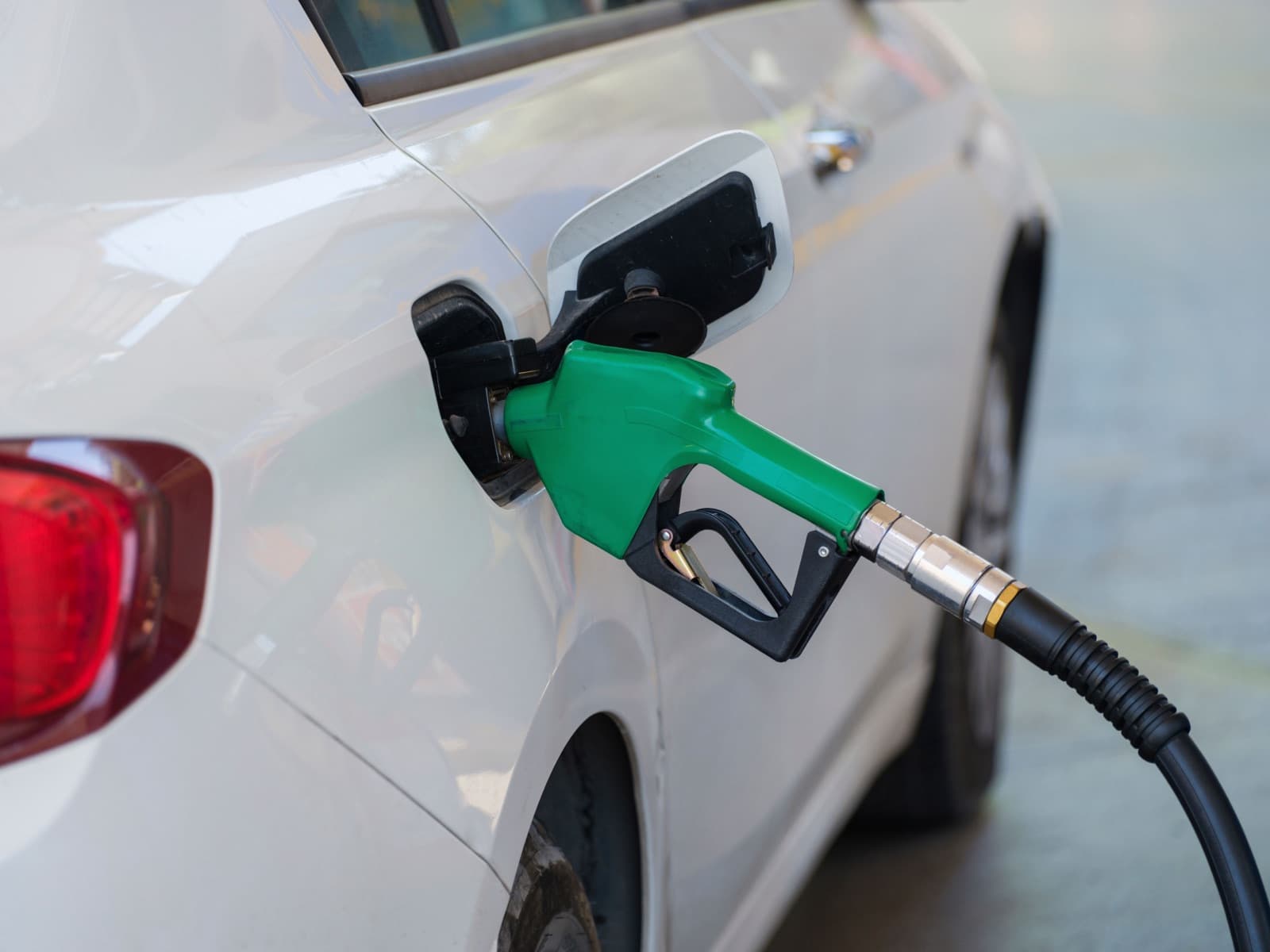 Fuel nozzle in a vehicle filler neck — petrol drivers in New Zealand pay road tax at the pump, diesel drivers pay road user charges instead