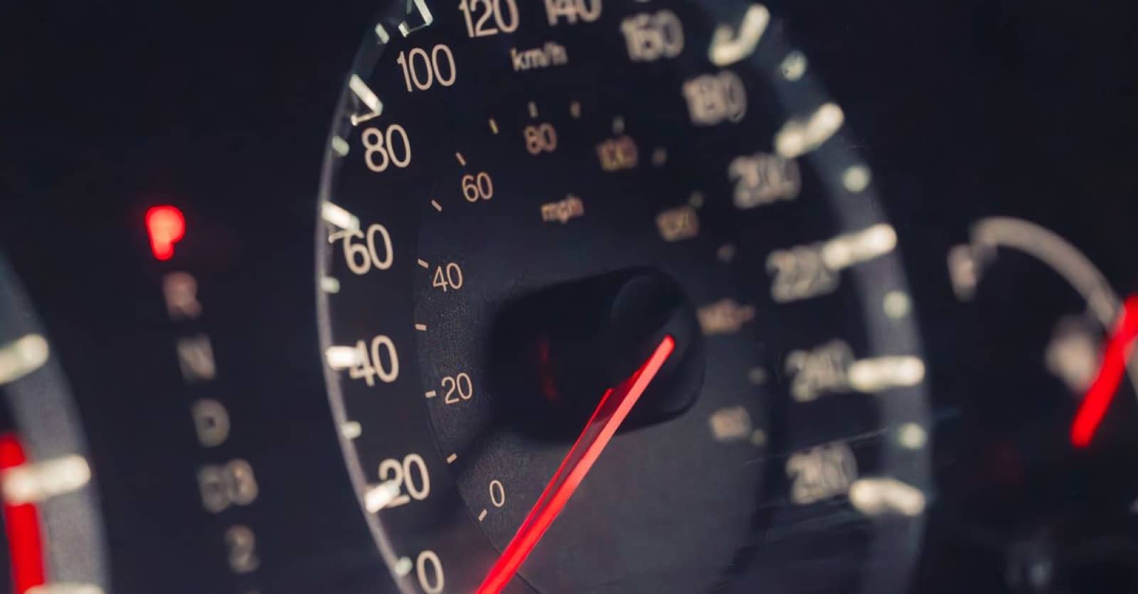 Car dashboard showing the speedometer and odometer in kilometres