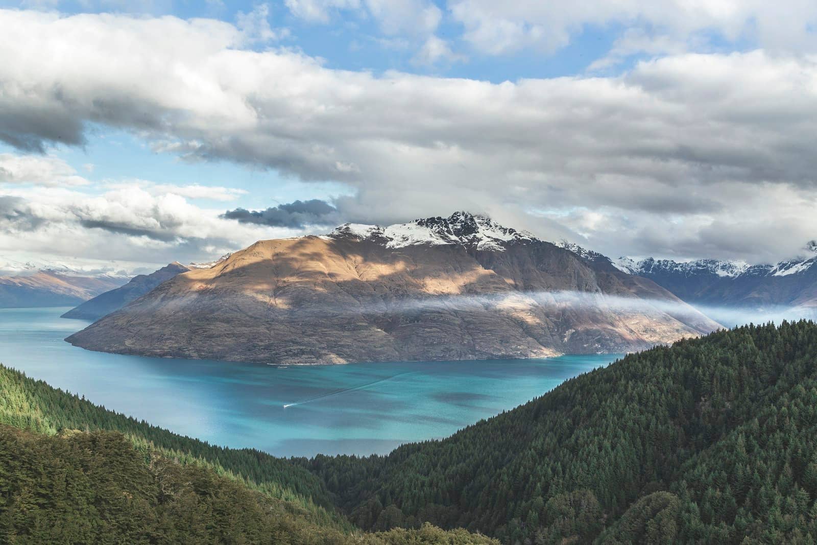 Dramatic New Zealand fjord landscape with mountains and still water